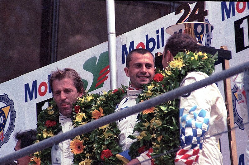 File:The winning trio of `Smokin` Jo Winkelhock, PierLuigi Martini & Yannick Dalmas celebrate on the podium at the 1999 Le Mans (51888476207).jpg