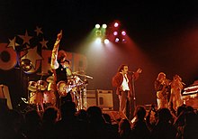 Trooper performing live in 1976. L-R: Tommy Stewart (view blocked), Brian Smith, Ra McGuire, Doni Underhill, Frank Ludwig TrooperLiveIn75.jpg