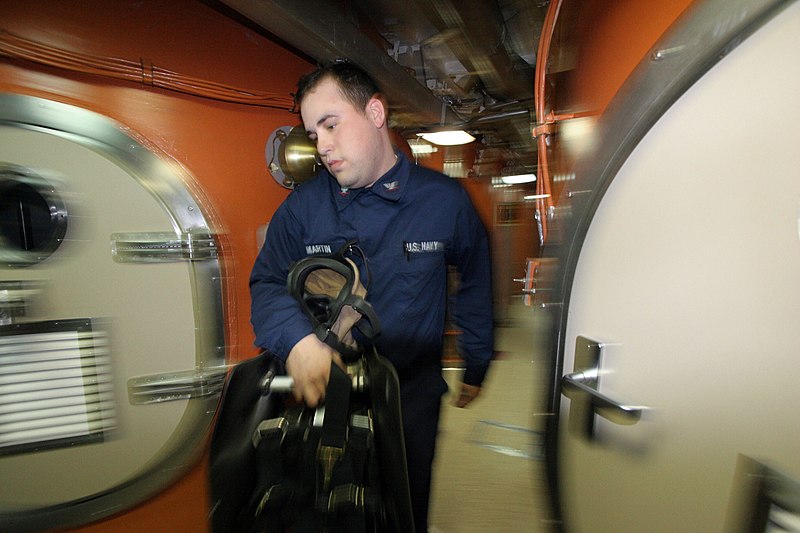 File:US Navy 060517-N-6027E-007 Electronics Technician 3rd Class Nicholas Martin carries an oxygen breathing apparatuses (OBA) during a battle stations drill aboard the Ohio-class guided-missile submarine USS Florida, (SSGN 728).jpg