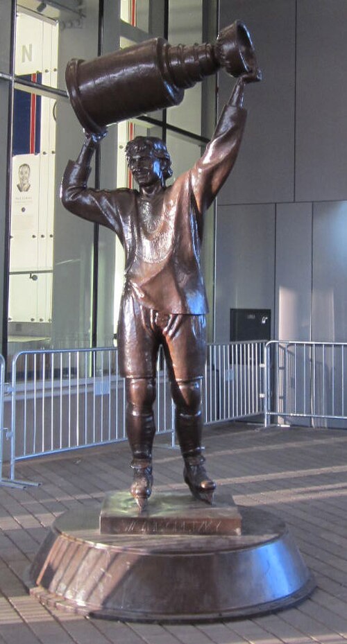 A statue, located outside Rogers Place in Edmonton, of Gretzky hoisting the Stanley Cup, which the Oilers won four times with him. Sculpted by John We