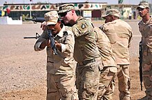 A trainer with Company A, 1st Battalion 502nd Infantry Regiment, Task Force Strike, 101st Airborne Division assisting Iraqi army ranger students during a room clearing drill at Camp Taji, Iraq on 18 July 2016 101st-Airborne-Soldiers-build-elite-Iraqi-force-with-Ranger-Training-7-480x319.jpg