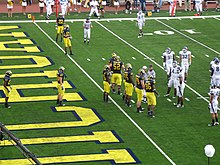 2010 Michigan Wolverines football team offense including #16 Denard Robinson, #20 Michael Shaw, #22 Darryl Stonum, #12 Roy Roundtree, #86 Koger, #52 Stephen Schilling, and #50 David Molk as well as #79 Perry Dorrestein, #65 Patrick Omamehand, and #72 Mark Huyge 20100904 Michigan Offense vs. Connecticut.jpg