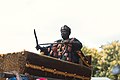 African riding and dancing in his palanquin