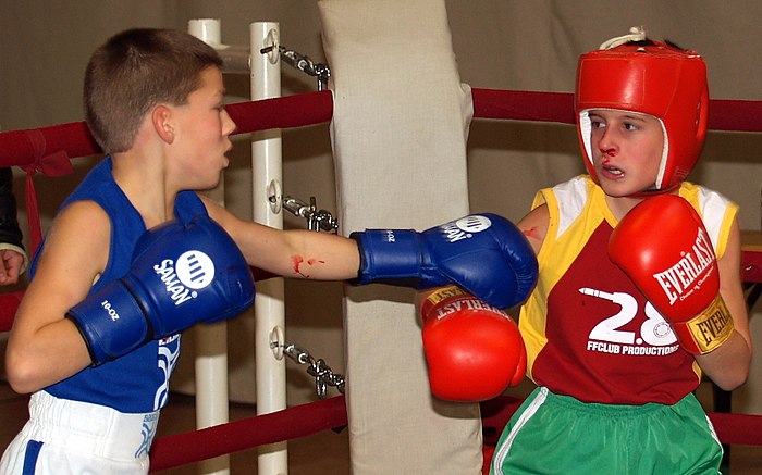 Two children boxing, the one on the right having a nosebleed due to a punch to the face, in Vecsés, Hungary in November 2006