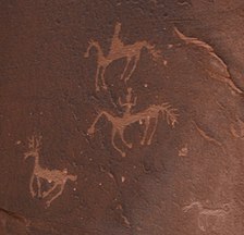 Petroglyphs of riders hunting antelope