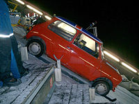 To get it into position, the Mini was winched to the top of the slope along the specially cut groves for the jump. The custom-made skis can be seen beneath the car's tyres Car on jump Top Gear mini winter olympics.jpg