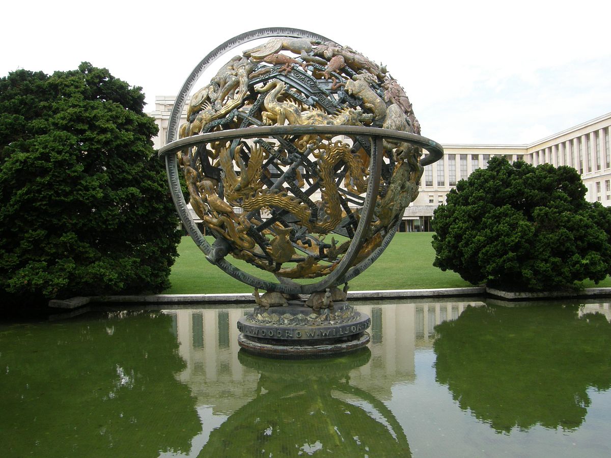 A large celestial sphere as a sculpture in a pond, made of up several animals 