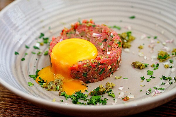 Beef steak tartare with raw egg yolk