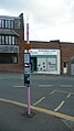 English: The Cowes Co-op bus stop, in Carvel Lane, Cowes, Isle of Wight, outside the Co-op supermarket. When seen here it was served by Southern Vectis route 1 and Wightbus routes 30 and 32, although only a Southern Vectis bus stop flag is fitted. It is the main bus stop in Cowes town centre. Also when seen, the bus stop pole had been painted pink, I'm not entirely sure why but I think it was something to do with supporting a charity.