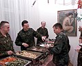 DD-SD-00-00201 COL Pazderski (German Army) stationed at the German Residency, in Sarajevo, helps serve Christmas dinner to US Army soldier..jpeg