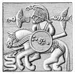 Del av hjälm, tunn, pressad bronsplåt. Funnen i Vendel. Figuren föreställer möjligen Oden och hans två korpar Hugin och Munin.