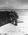 Dr Lauren R Donaldson and team member checking a pontoon for radiation on Bikini beach, summer 1947 (DONALDSON 38).jpeg
