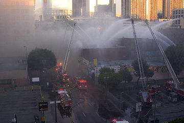 Several aerial apparatus in use at a fire in Los Angeles