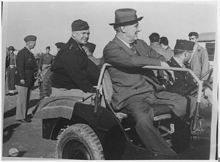 General Eisenhower, General Patton (standing to the left) and President Roosevelt in Sicily, 1943