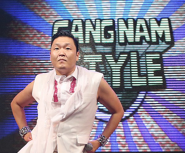 Psy with the Gangnam Style logo