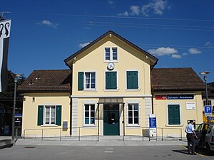 Two-story yellow station building with hip roof