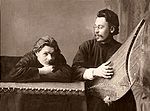 Maxim Gorky (left) and Stepan Skitalets playing a gusli, 1900