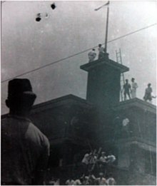 A moment after the blue stripe of a Dutch flag was torn off to make an Indonesian flag at the Hotel Yamato (now Hotel Majapahit), Surabaya Hote-orange.jpg