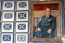 Bill Struth's portrait in the trophy room at Ibrox, hanging beside some of the league championship flags his teams won, including 11 out of 13 between 1922 and 1935. Ibrox trophy room.jpg