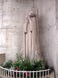 Joan of Arc in Rouen. Statue by Maxime Real del Sarte. Joan is burnt at the stake and we see the flames already catching the bottom of her robe. The statue is known as "Jeanne au bucher" Joan of Arc Roen Burning place IMG 1602.JPG