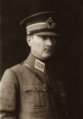 With peaked cap and military uniform