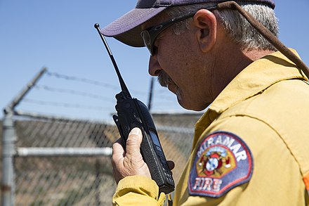 Firefighter using modern walkie-talkie