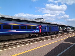 A locomotive and Mk3 carriage standing at Reading