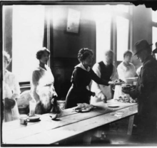 The strike committee set up soup kitchens and distributed as many as 30,000 meals each day. In the photo, a woman serves a plate of food to a striking worker. Serving Food Seattle Strike 1919.png