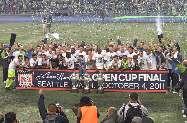 Sounders FC players with the 2009, 2010, and 2011 U.S. Open Cup trophies