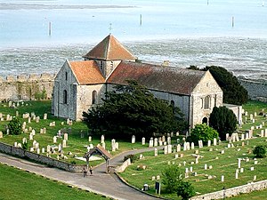 St Mary's Church, seen from Portchester Castle, was built in the early 12th century within the walls of a Roman fort. St. Mary's, Portchester in its churchyard - geograph.org.uk - 664523.jpg