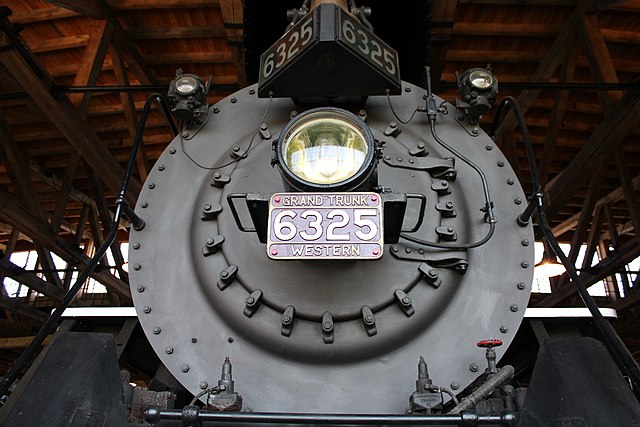 A close-up of No. 6325's headlight and numberplate