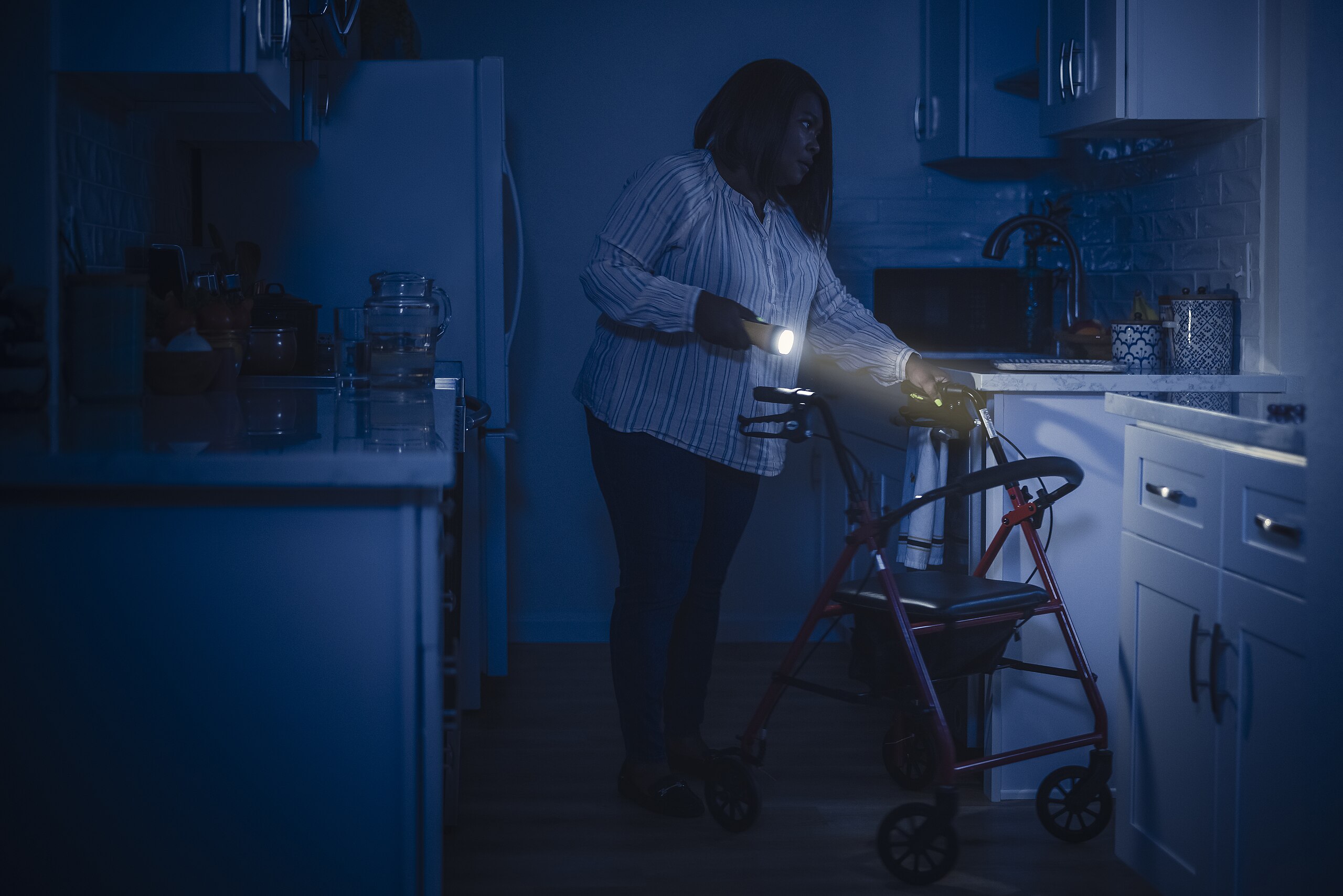 File:Storm Safety - Person who uses a walker using a flashlight in