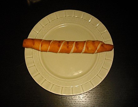 A tequeño is prepared with bread dough with queso blanco duro (hard white cheese) in the middle.