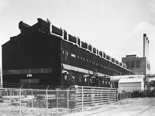 Thermal Diffusion Process Building at S-50. The building in the background with the smokestacks is the K-25 powerhouse.