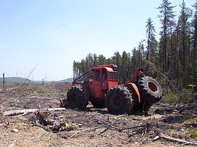 A skidder is used to clear forest and move logs.