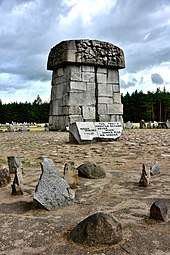 Treblinka memorial in 2018. Plaque states never again in several languages. Treblinka death camp 2018i.jpg