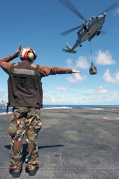 File:US Navy 020902-N-1058W-054 Aviation Structural Mechanic Airman from Makeyeuka, Russia, directs a pilot of an HH60H "Sea Hawk".jpg