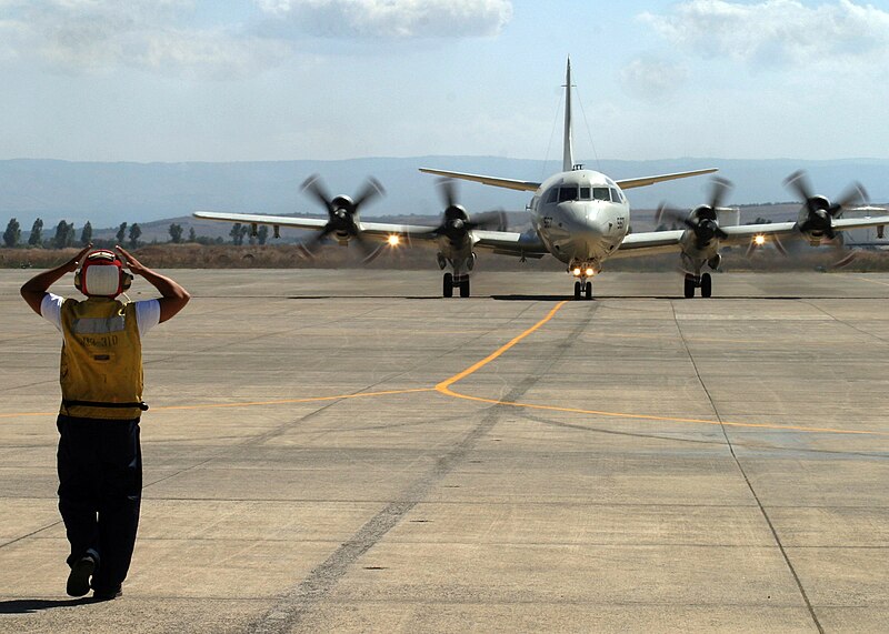 File:US Navy 060823-N-3013W-003 Aviation Ordnanceman 3rd Class Giancarlo Rosasarias of Los Angeles, Calif., directs the taxi pilot to straighten his direction of movement in order to properly park a P-3C Orion, after returning from.jpg