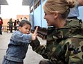 US Navy 070810-N-0194K-279 U.S. Air Force Staff Sgt. Sarah Boyll, an Air National Guard dental technician from the 181st Fighter Wing attached to hospital ship USNS Comfort (T-AH 20), high-fives a young child.jpg
