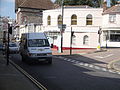 Wightbus 5899 (HX04 SYC), an Iveco 40C Euromaster 9 seater, in the High Street, Ventnor, Isle of Wight on route 31. It is seen on the last day Wightbus operated route 31, although the bus was still being driven by a Southern Vectis driver. As a result, a small bunch of flowers is visible on the windscreen, to comemorate the route. A revised route is now operated by Island Minibus Services.