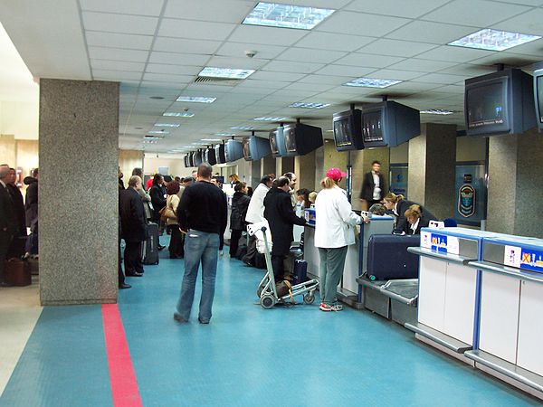 Luggage is weighed as passengers check in at the airport