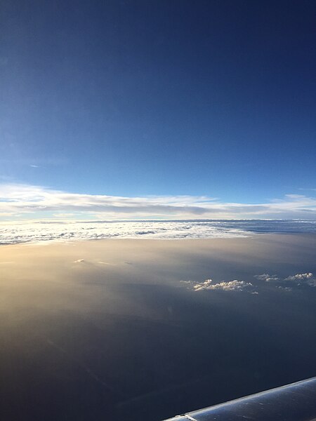 File:2015-07-10 19 56 24 Clouds and dusty crepuscular rays over McCurtain County, Oklahoma viewed from an airplane flying from Washington Dulles International Airport to Dallas-Fort Worth International Airport.jpg