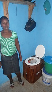 A portable urine-diverting dry toilet as marketed by SOIL in Haiti under the name "EkoLakay" A SOIL EkoLakay toilet customer. (15921409131).jpg
