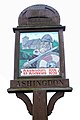 Village sign showing St Andrew's church and King Canute