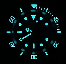 Phosphorescent elements of a wrist watch that had been exposed to bright (ultraviolet) light BWG9 lume on a Rolex Submariner Date style Steeldive homage watch.jpg