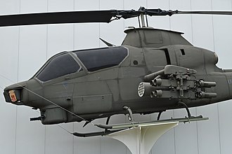 An AH-1S showing the cutters above and behind the cockpit and below the fuselage. It also has an additional cutter below the front gun turret. Bell AH-1S Cobra 0-17109 (10562355843).jpg