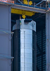 Top of a steel booster inside a construction bay