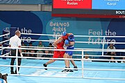 Deutsch: Boxen bei den Olympischen Jugendspielen 2018 Tag 12, 18. Oktober 2018 - Kampf um Bronze im Leichten Schwergewicht Jungen – Karol Itauma (Großbritannien, blau) schlägt Ruslan Kolesnikov (Russland, rot) 4-1; Ringrichter ist Alejandro Barrientos (Kuba). English: Boxing at the 2018 Summer Youth Olympics on 18 October 2018 – Gold Medail Match light heavyweight Boys - Karol Itauma (Great Britain, blue) beats Ruslan Kolesnikov (Russia, red) 4-1; Referee is Alejandro Barrientos (Cuba). Español: Boxeo en los Juegos Olímpicos Juveniles de Verano de 2018 en 18 de octubre de 2018 - Medalla de oro de los hombres de peso pesado ligero: Karol Itauma (Gran Bretaña, azul) vence a Ruslan Kolesnikov (Rusia, rojo) 4-1; El árbitro es Alejandro Barrientos (Cuba).