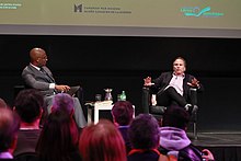 Harewood (left) interviews author Buzz Bissinger (right) in 2023 Buzz Bissinger at the Canadian War Museum (52637850119).jpg