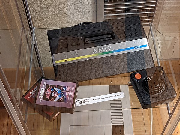 Atari 2600 (1986 model) with joystick and a copy of Joust. Renzo Renzi Library, Cineteca di Bologna